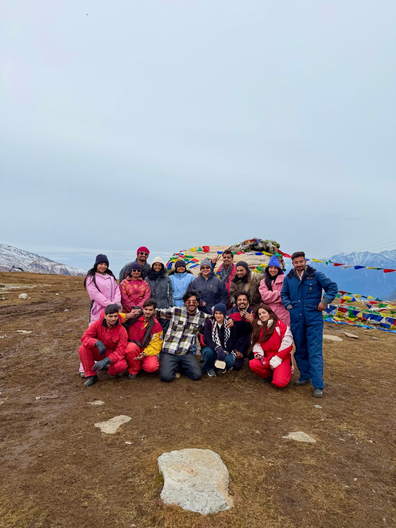 The group at a high mountain pass with colourful prayer flags