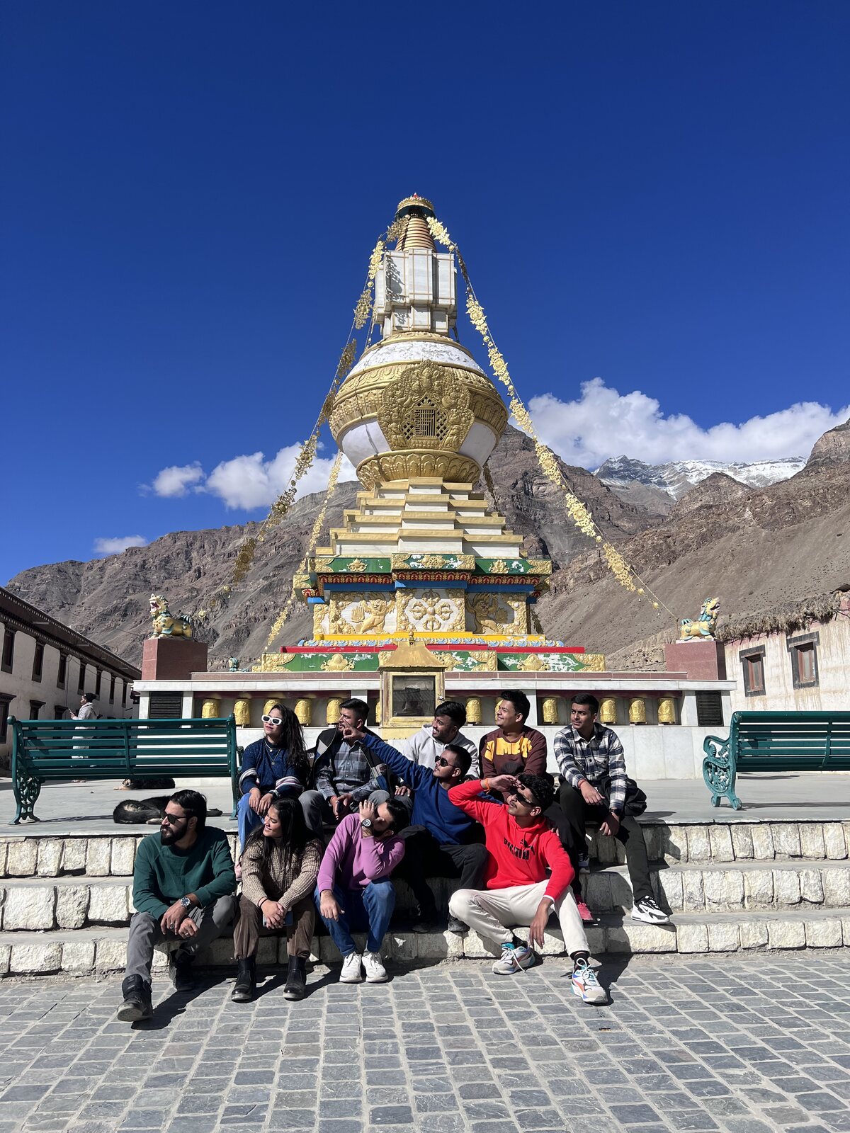 TRAVIA group sitting together in front of a golden stupa